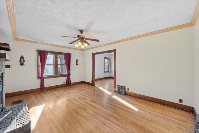 unfurnished living room featuring ceiling fan, light wood-type flooring, a textured ceiling, and ornamental molding