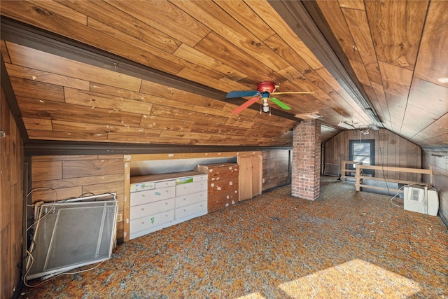 additional living space featuring dark carpet, lofted ceiling, wooden walls, ceiling fan, and wood ceiling