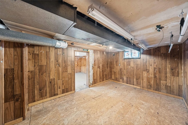 basement featuring wood walls