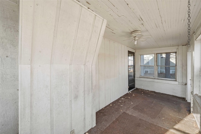 unfurnished sunroom with ceiling fan