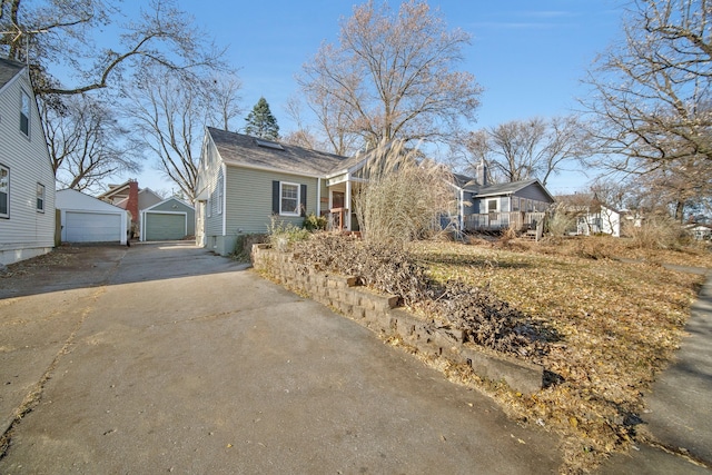 view of front of house featuring a garage and an outdoor structure