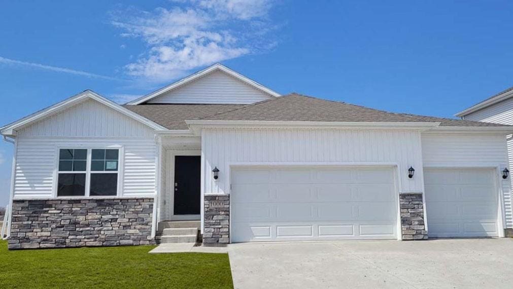 1380 NW Brandywine Ln, Waukee, IA 50263 - ranch-style home with an attached garage, a shingled roof, driveway, stone siding, and a front lawn