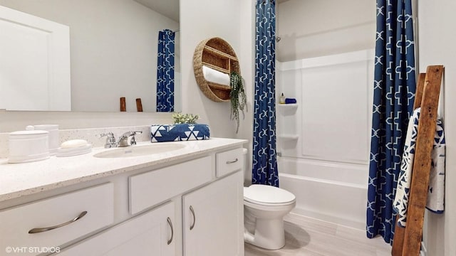 full bathroom with toilet, shower / tub combo, wood-type flooring, and vanity