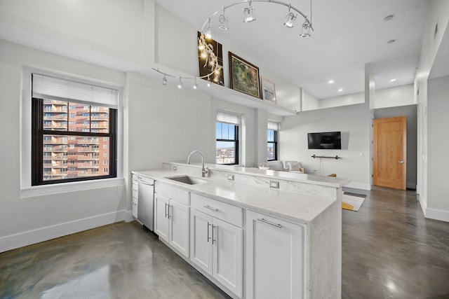 kitchen with white cabinets, dishwasher, a healthy amount of sunlight, and sink