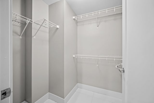 spacious closet featuring tile patterned floors