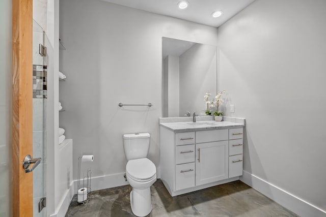 bathroom with vanity, concrete floors, and toilet