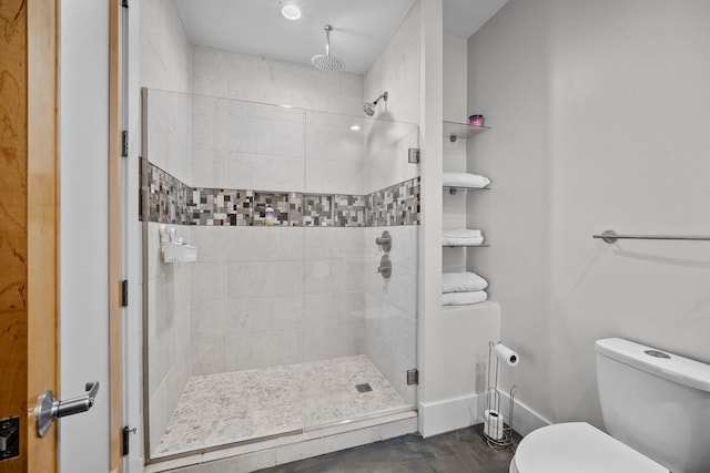 bathroom featuring toilet and an enclosed shower