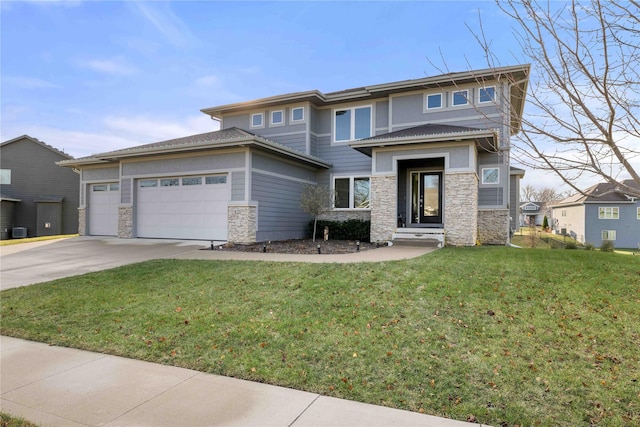 prairie-style home with a garage and a front lawn