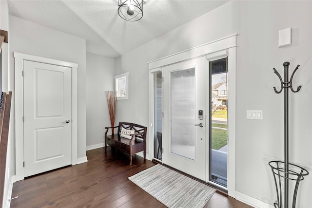 entrance foyer with a textured ceiling and dark wood-type flooring