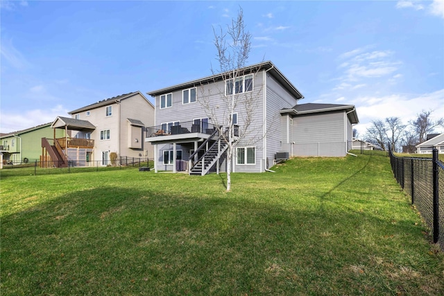 rear view of property with a lawn, central air condition unit, and a deck