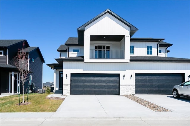 view of front of property featuring a balcony, a front lawn, central AC unit, and a garage