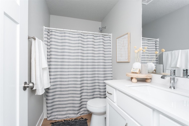 bathroom featuring hardwood / wood-style floors, vanity, a shower with curtain, toilet, and a textured ceiling