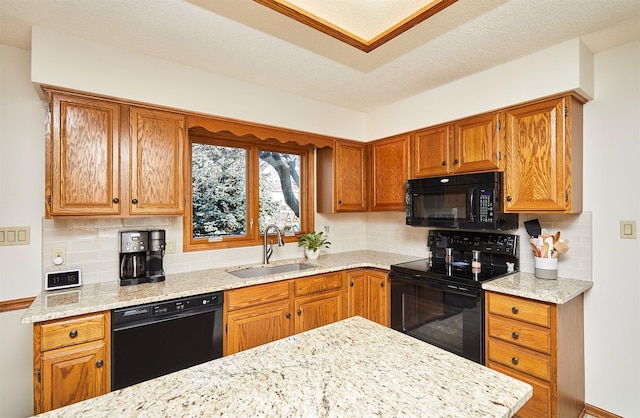 kitchen with backsplash, sink, black appliances, and a textured ceiling