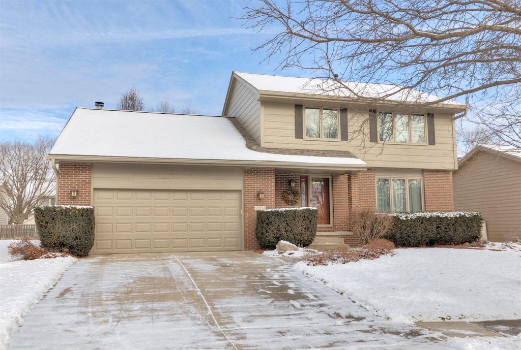 view of front of house with concrete driveway, brick siding, and an attached garage