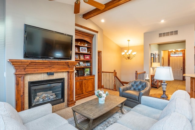 living room with ceiling fan with notable chandelier, vaulted ceiling with beams, built in features, a fireplace, and light tile patterned flooring