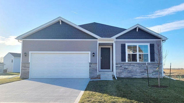 1223 NE Deerfield Dr, Ankeny, IA 50021 - view of front of property with stone siding, a front yard, concrete driveway, and a garage