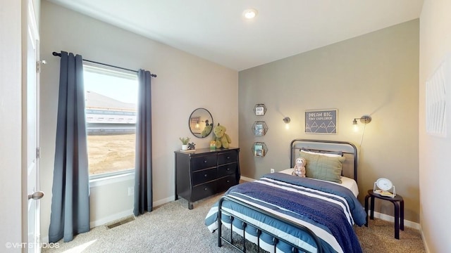 bedroom featuring light colored carpet