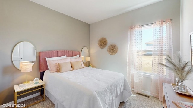 bedroom with light colored carpet