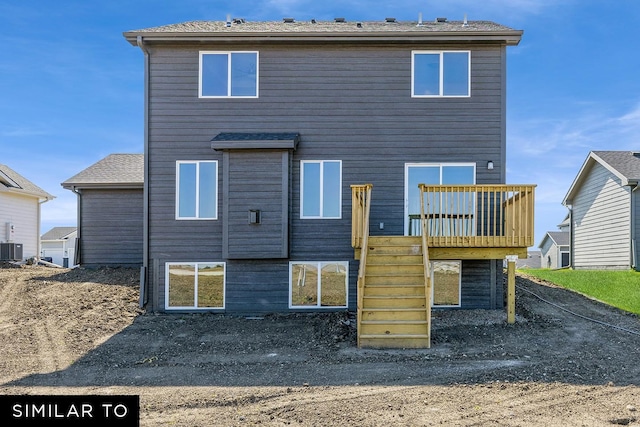 rear view of property with cooling unit and a wooden deck