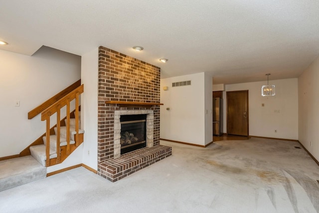 unfurnished living room with a fireplace, a textured ceiling, and carpet flooring