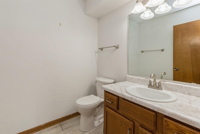 bathroom with tile patterned flooring, vanity, and toilet