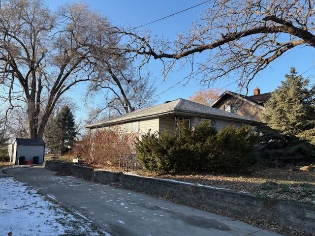 view of home's exterior featuring a shed