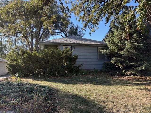 view of property exterior with a lawn