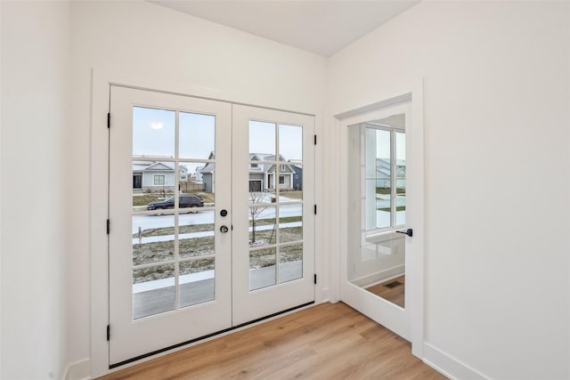 entryway featuring french doors, light hardwood / wood-style flooring, and a wealth of natural light