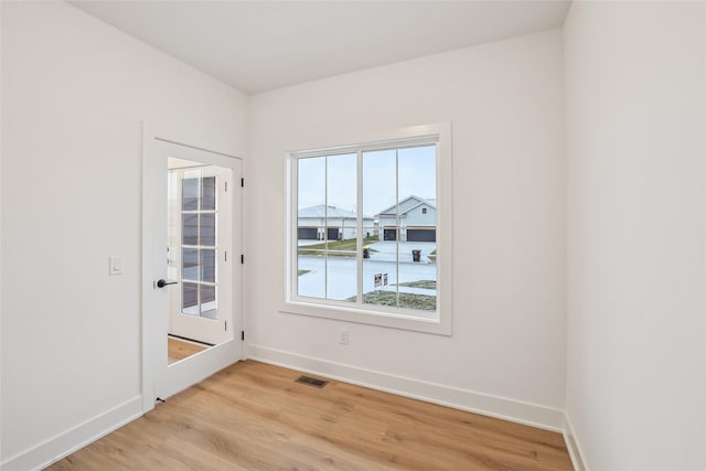 unfurnished room with light hardwood / wood-style floors