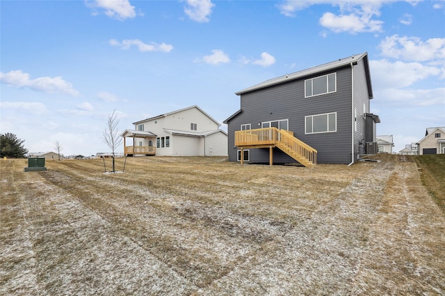 rear view of property featuring a deck