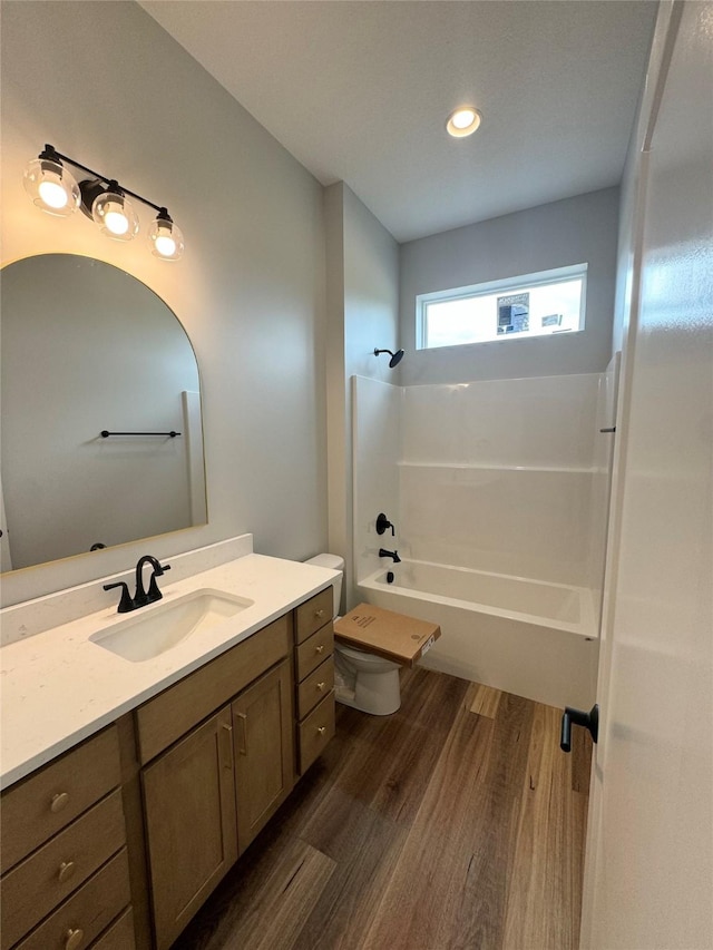 203 Hudson Ave, Van Meter, IA 50261 - bathroom with vanity, wood finished floors, toilet, shower / tub combination, and recessed lighting