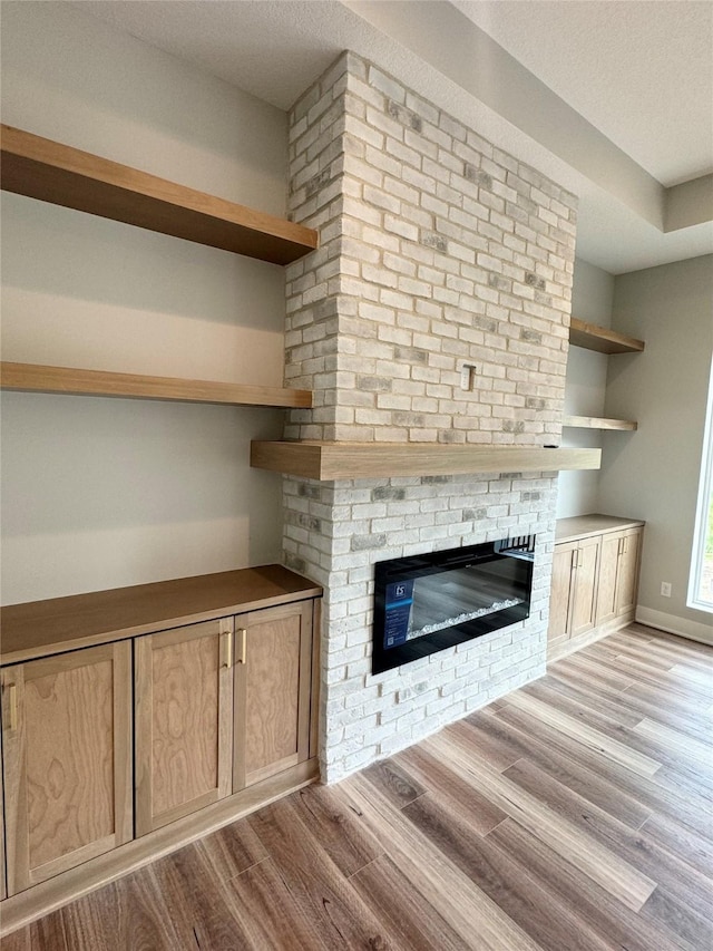 203 Hudson Ave, Van Meter, IA 50261 - detailed view of wood finished floors and a fireplace