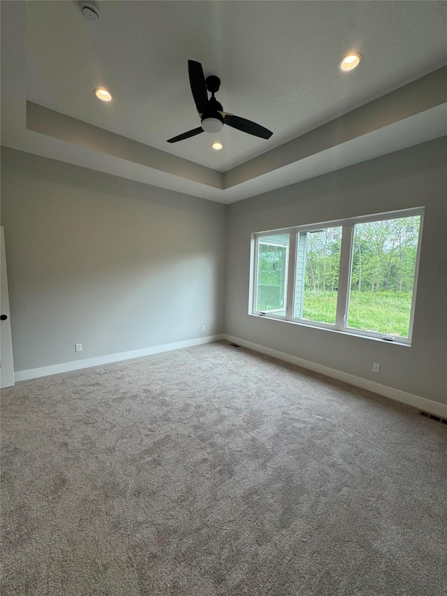 203 Hudson Ave, Van Meter, IA 50261 - carpeted spare room featuring a tray ceiling, baseboards, recessed lighting, ceiling fan, and a smoke detector