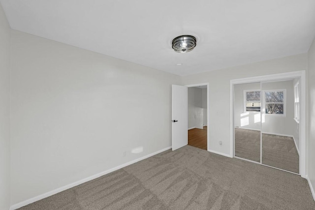 unfurnished bedroom featuring carpet and a closet