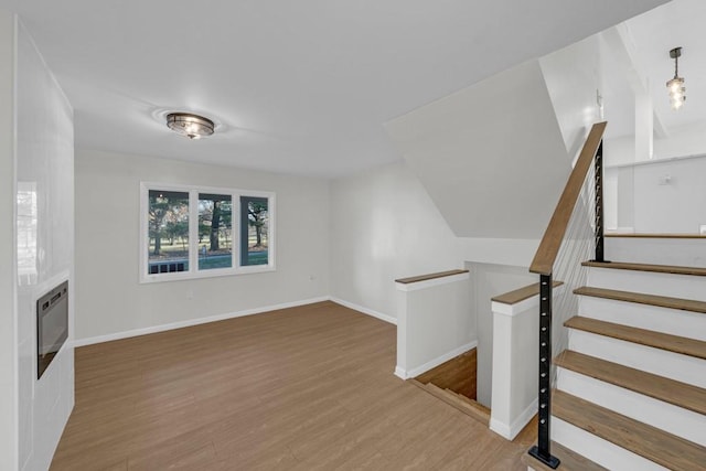 unfurnished living room with hardwood / wood-style flooring and heating unit