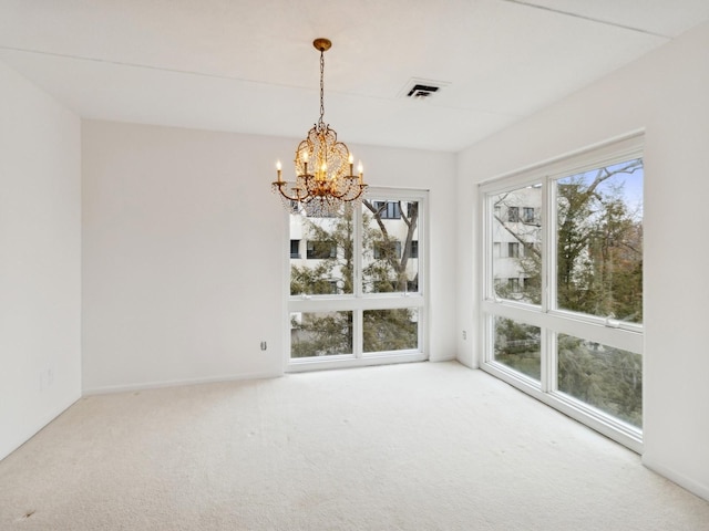 unfurnished dining area featuring carpet and a chandelier