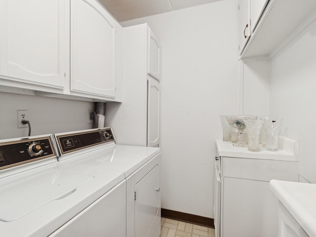 washroom featuring cabinets and washing machine and dryer