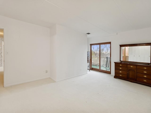 unfurnished bedroom featuring access to outside and light colored carpet