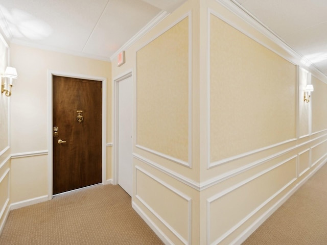 hallway with carpet flooring and ornamental molding