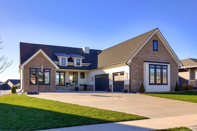 rear view of house featuring a lawn and a garage