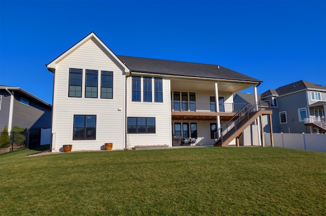 rear view of property featuring a yard and a balcony