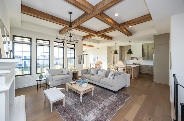 living room with beamed ceiling, a notable chandelier, dark hardwood / wood-style floors, and coffered ceiling