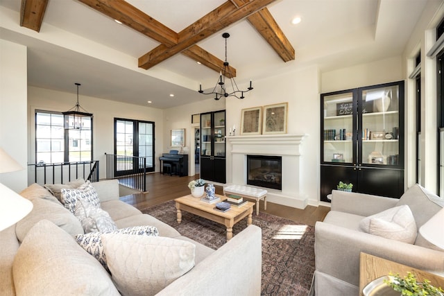 living room featuring french doors, coffered ceiling, a notable chandelier, beamed ceiling, and dark hardwood / wood-style floors