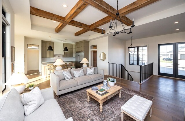 living room featuring beamed ceiling, dark hardwood / wood-style floors, a notable chandelier, and coffered ceiling