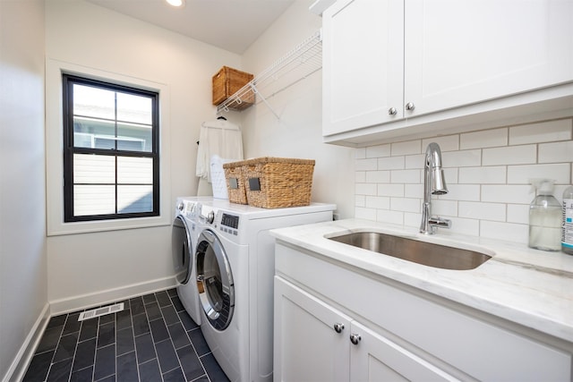 washroom with washer and clothes dryer, sink, and cabinets