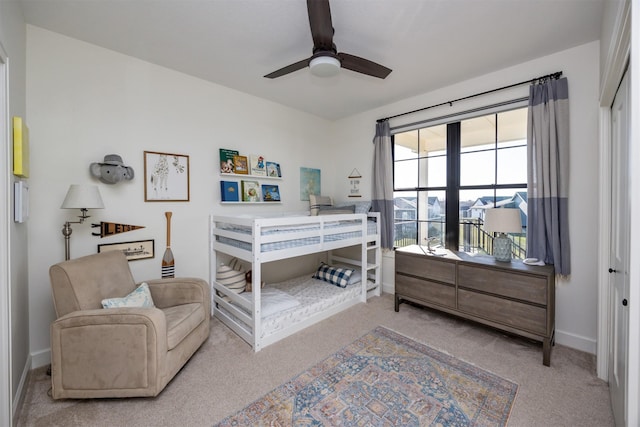 bedroom featuring ceiling fan, a closet, and light carpet