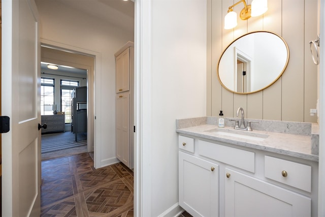 bathroom featuring vanity and parquet flooring