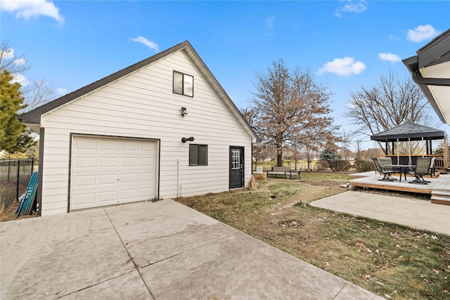 view of side of home featuring an outbuilding, a garage, a gazebo, and a patio