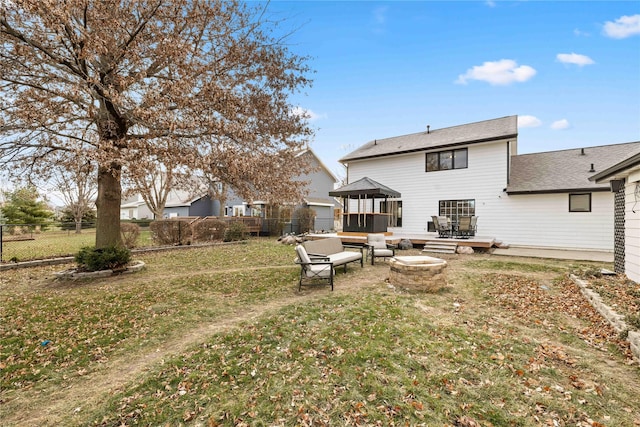 back of house with a yard, a patio area, a gazebo, and an outdoor fire pit