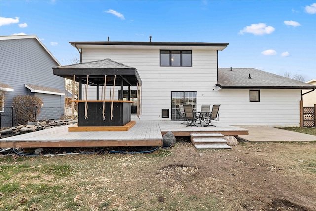 back of house featuring a deck